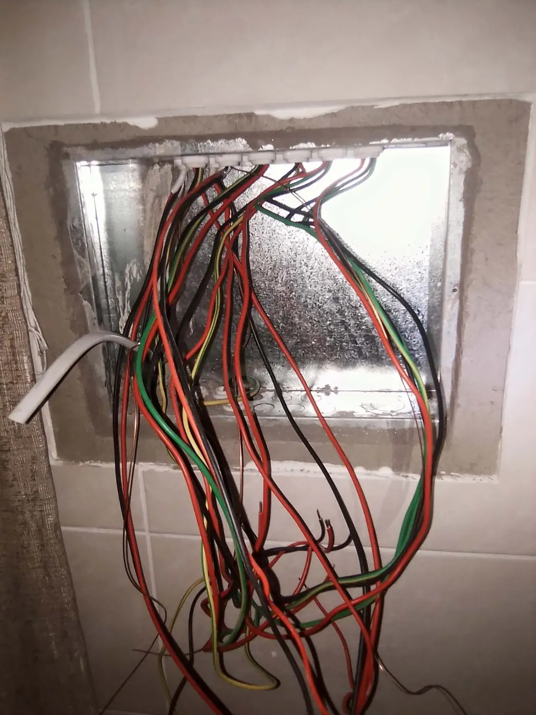 Distribution box opening with new house wiring pulled through