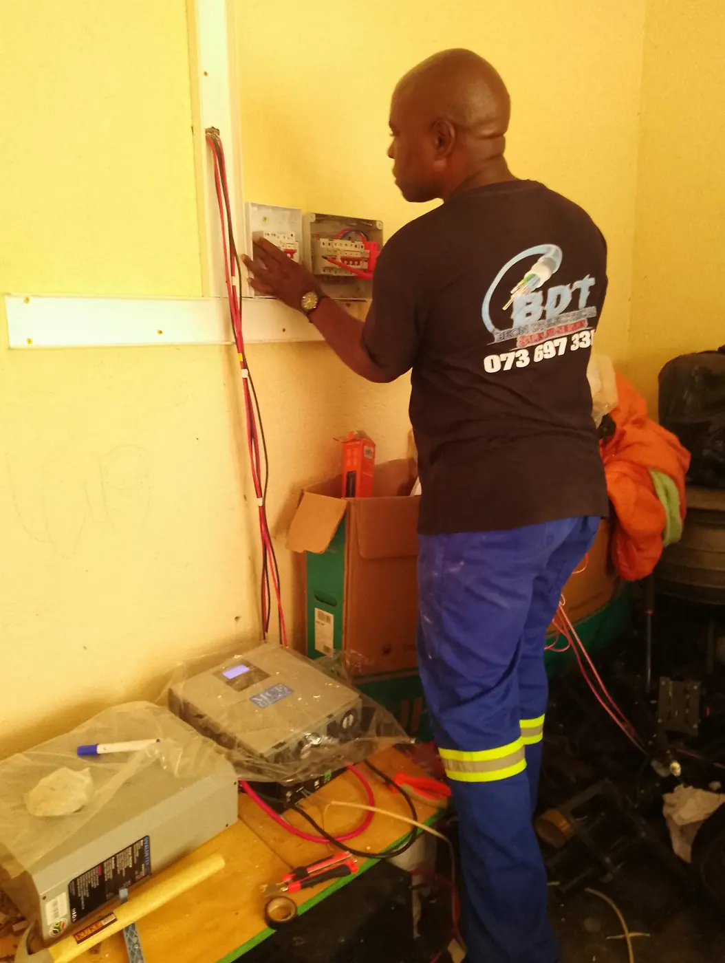 Beon DT technician wiring an inverter and DB board